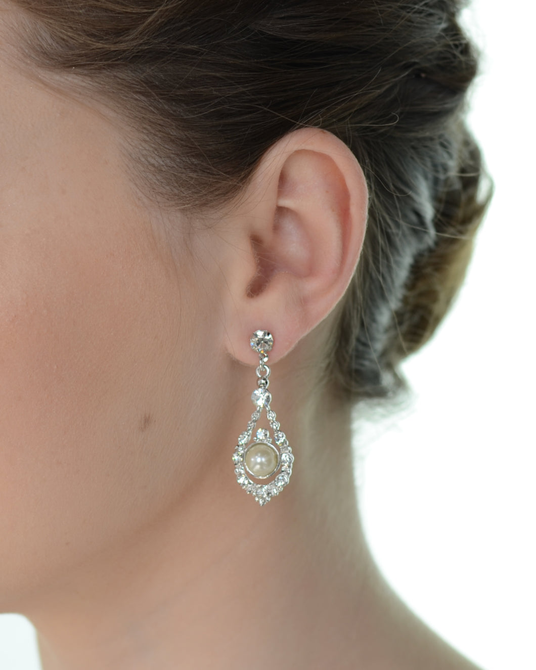 Close-up of a woman wearing a sparkling earring with a blurred background