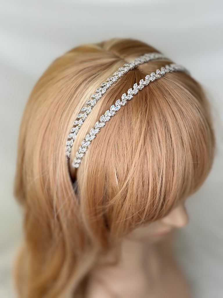 a double row silver crystal bridal headband on a models head