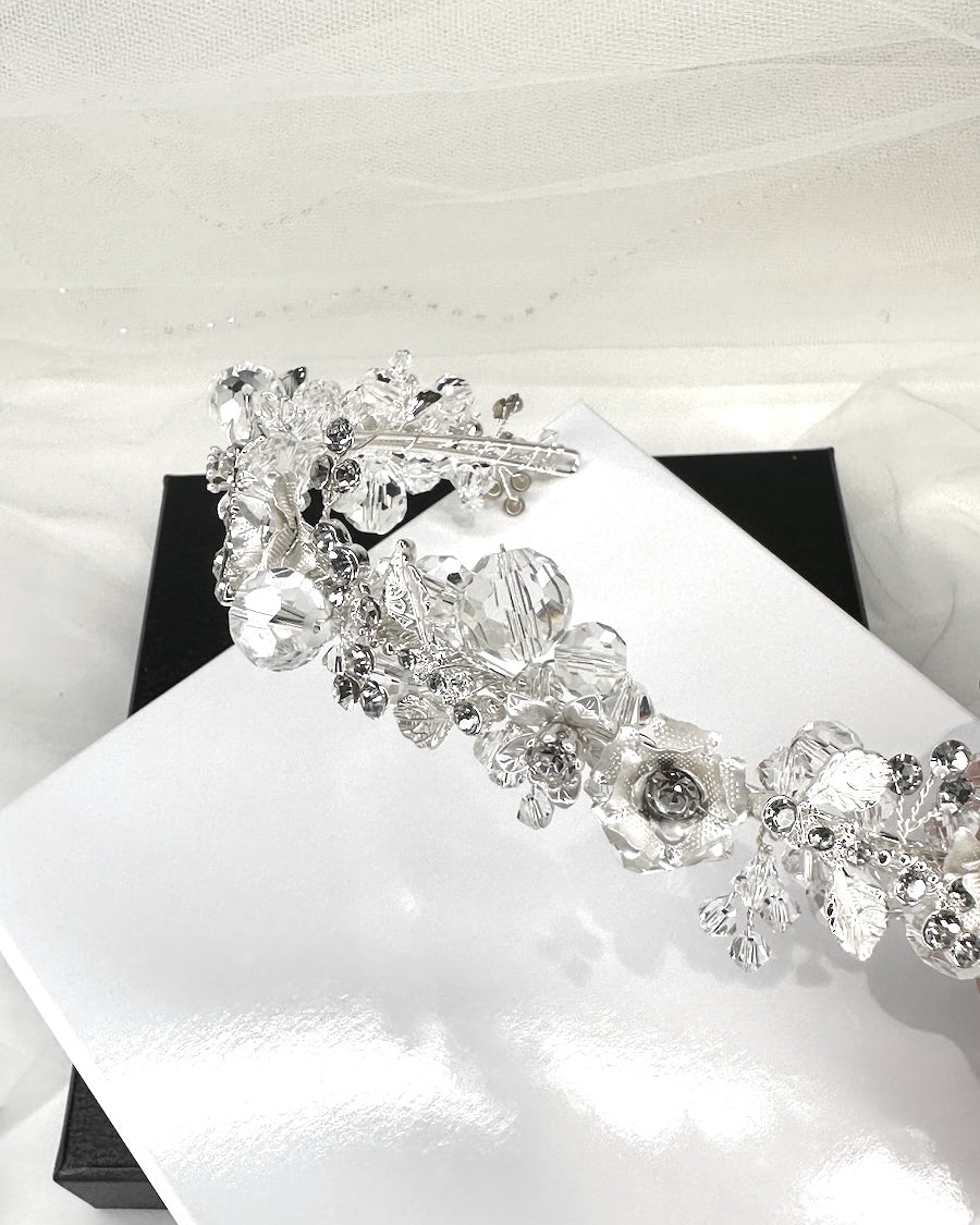 A headband with silver ball crystals called Quinn shown in a display box