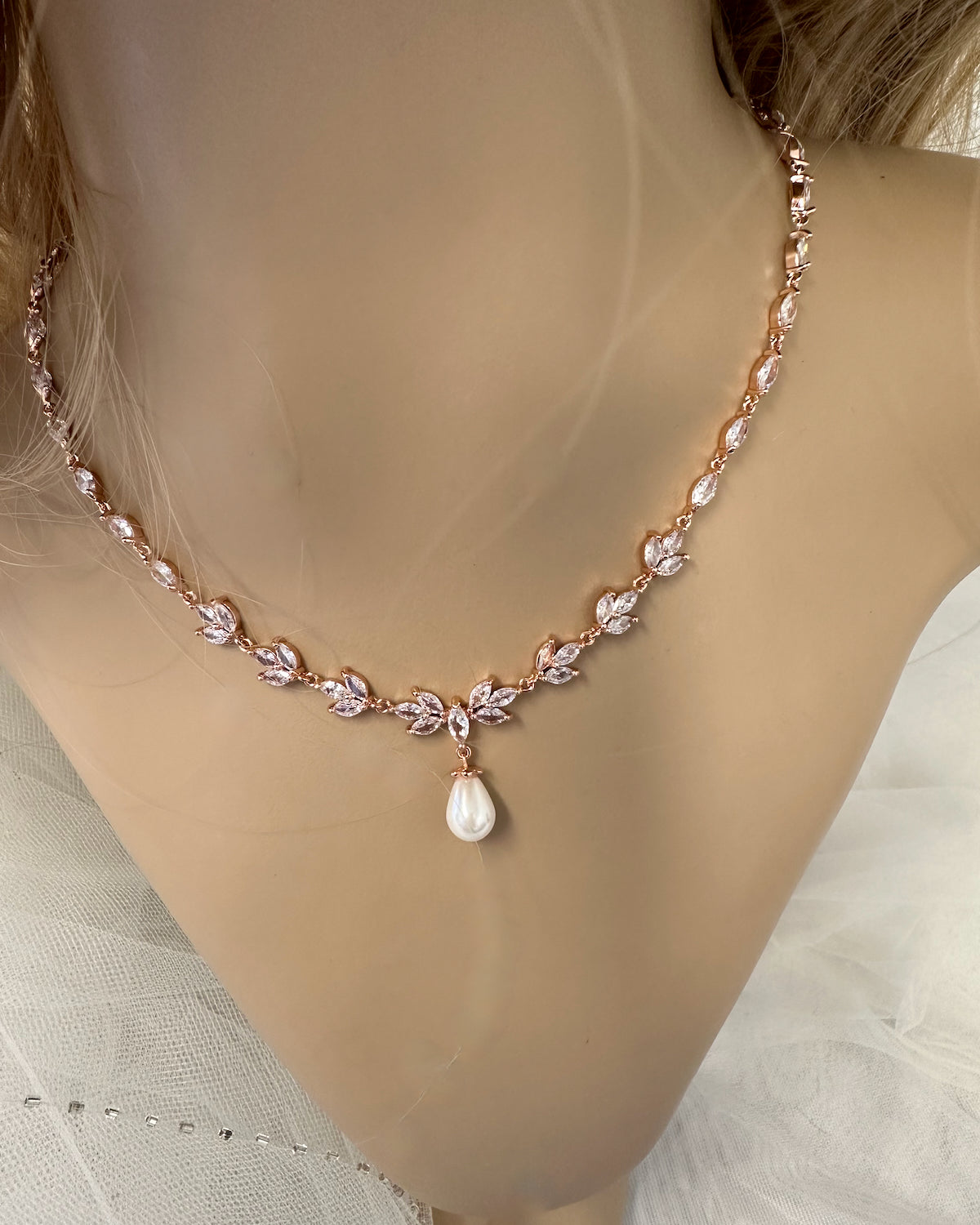 A Leah rose gold bridal necklace worn on a model neck