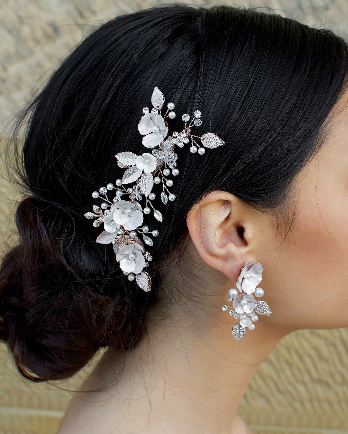 Pale Rose Gold Hair Clip with pearl flowers shown on dark hair
