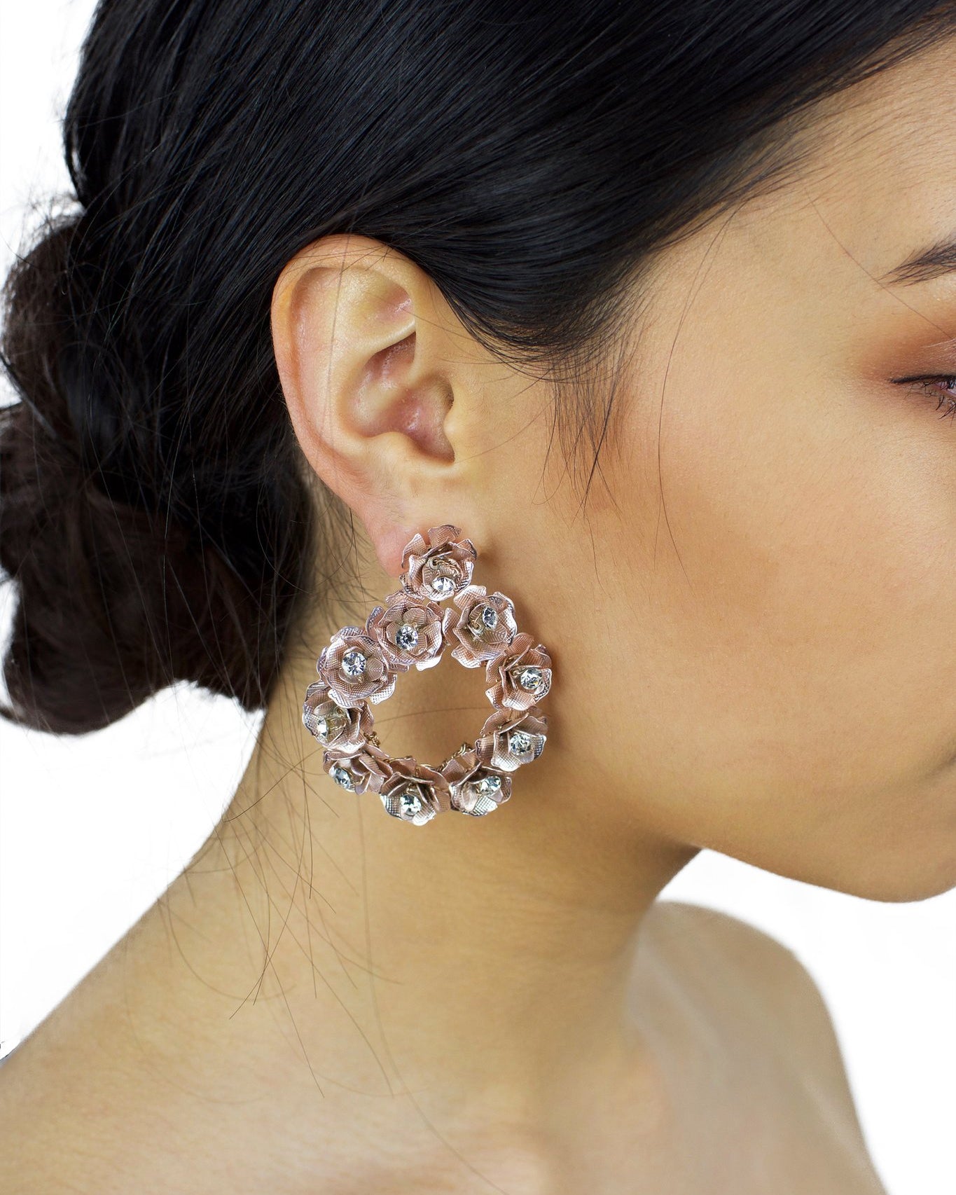 Rose Gold ring of flowers earring worn by a dark hair model
