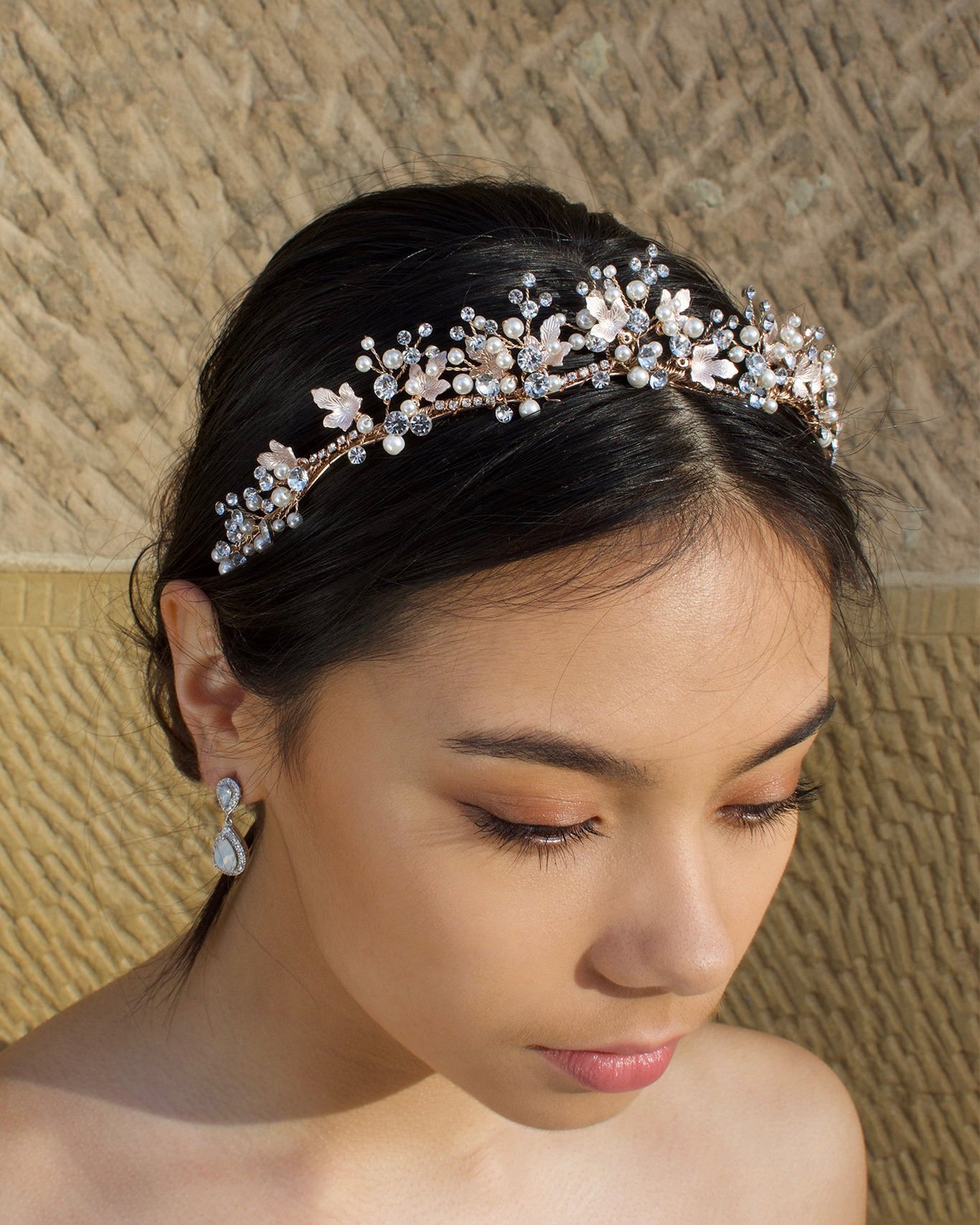 Low Pale Rose Gold Tiara with pearls made with five points worn by a dark hair bride