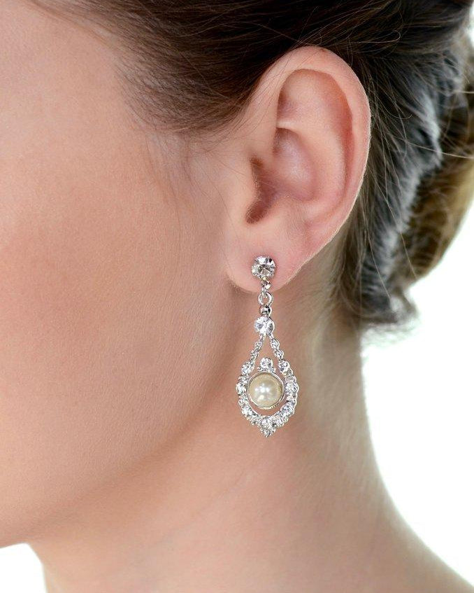 A models' ear wears a pearl drop earring against a white background