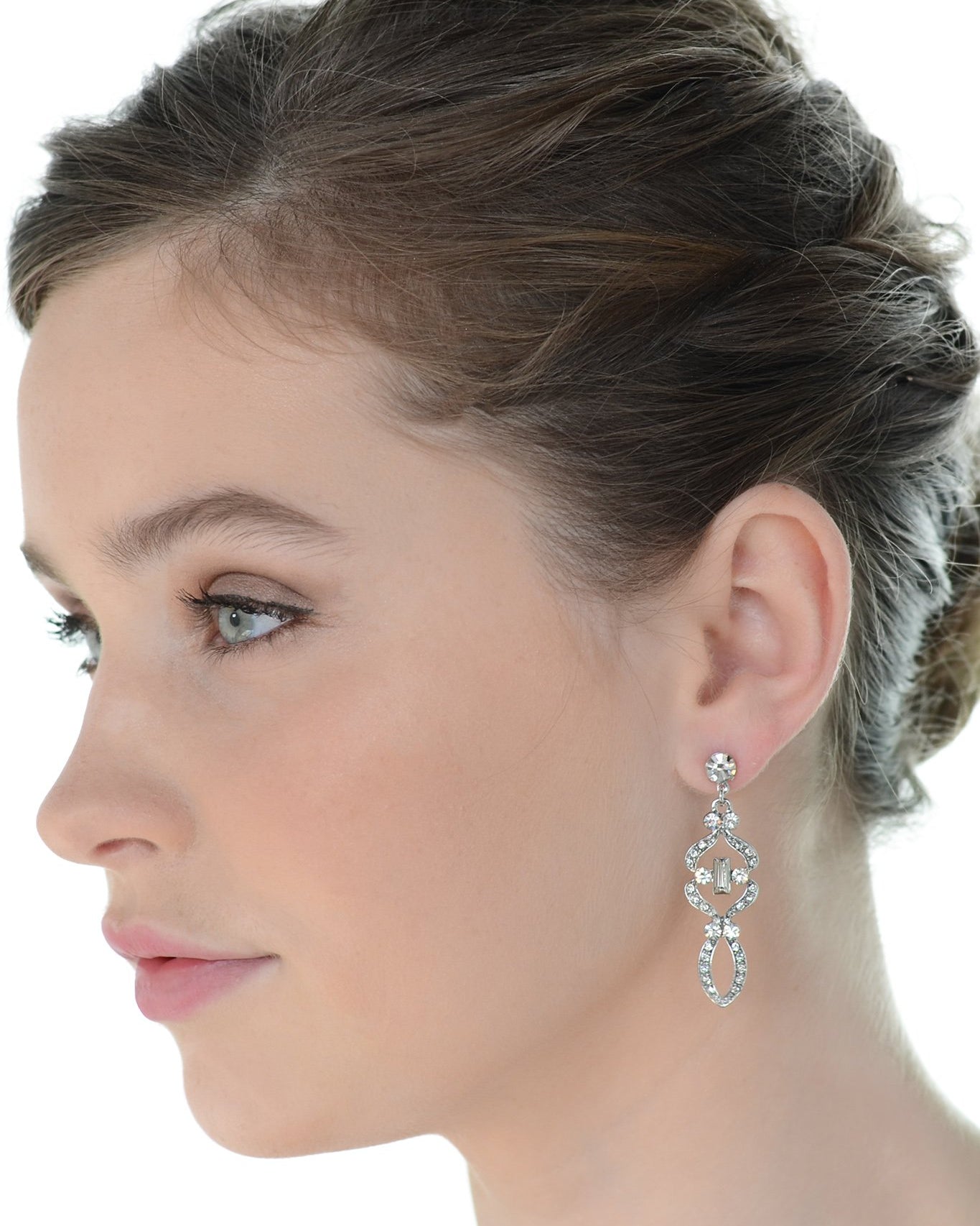 Beautiful short brown hair bride wearing a mid length drop earring with a white background