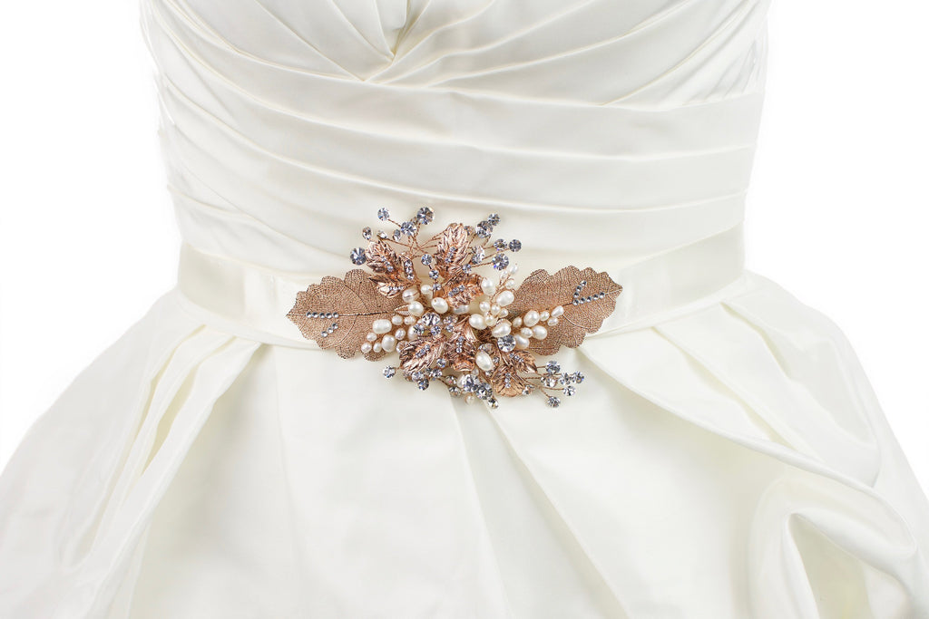 Rose Gold Leaves Motif on an ivory satin ribbon worn on an ivory satin bridal gown