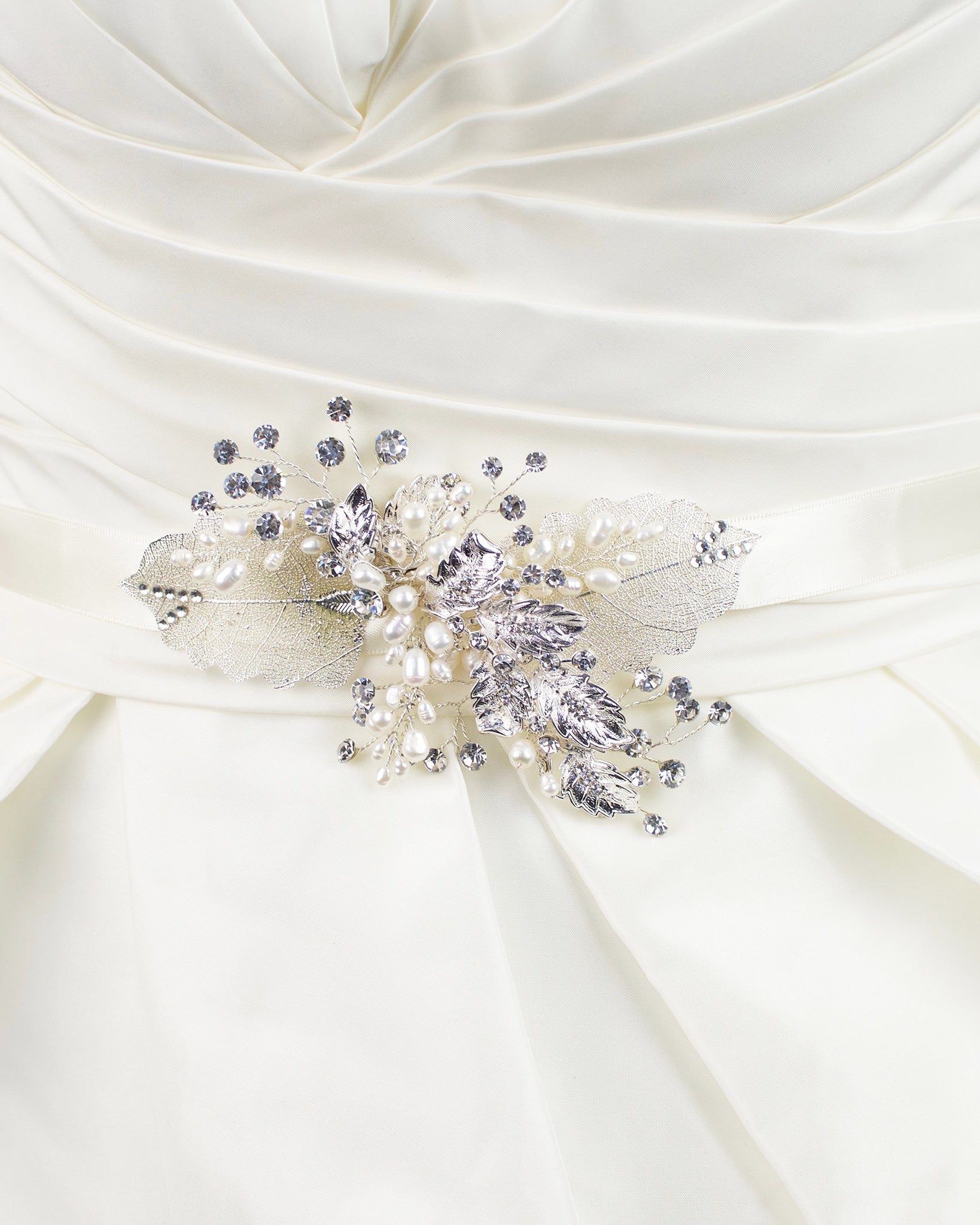 Silver filigree leaves and real pearls are on a Bridal Belt made on ivory satin and worn on an ivory satin gown