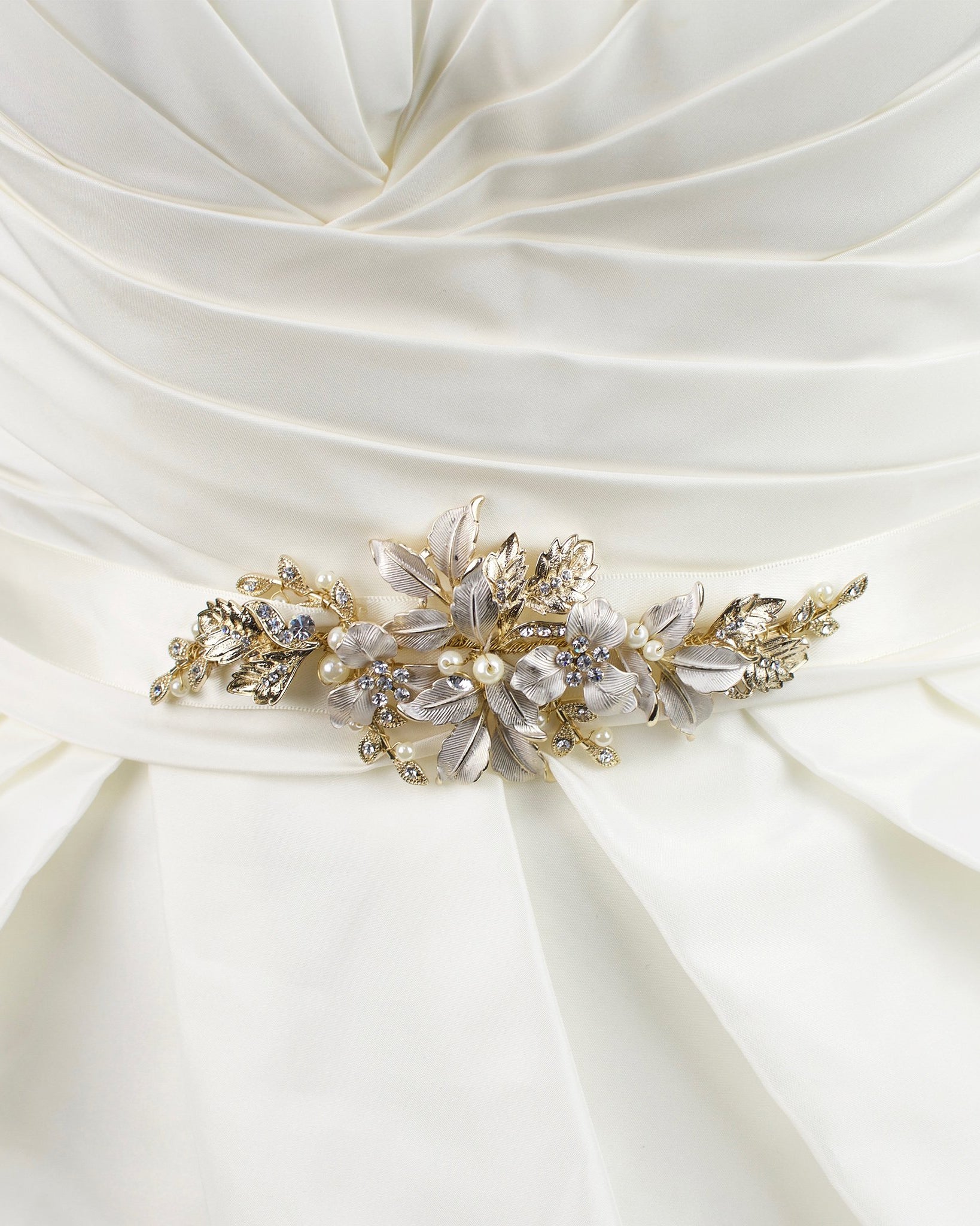 Pale Gold leaves and flowers motif on an ivory satin ribbon worn on an ivory bridal gown.