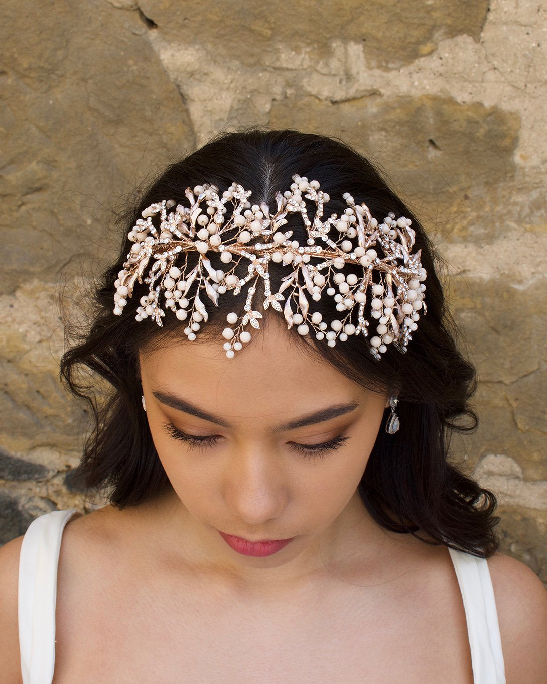 Rose Gold Bridal Headband with coral colour beads worn at the front of a brides head