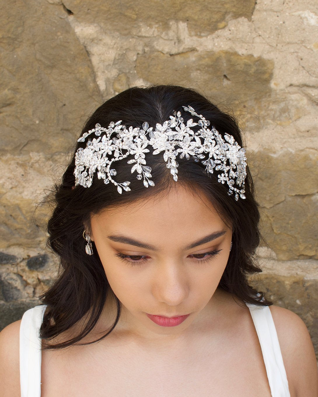 Silver and crystal headband worn by a bridal model at the front of her head