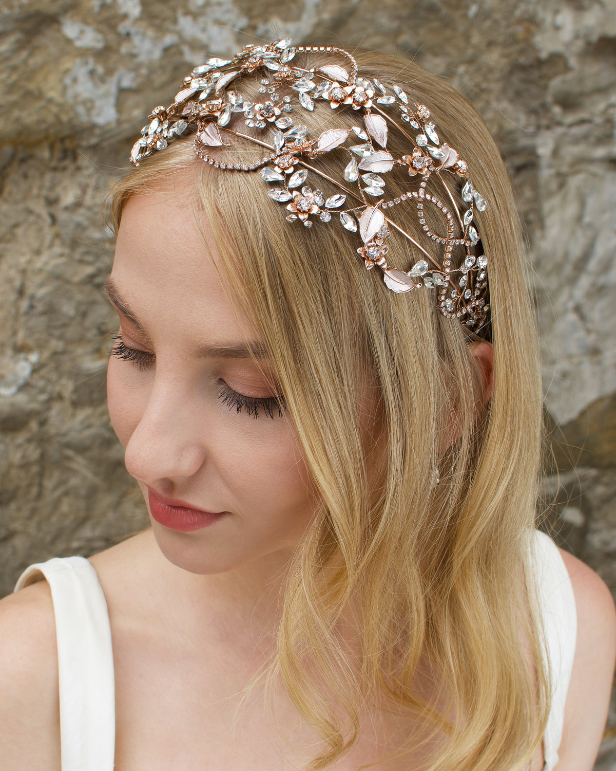 Rose Gold headband with clear stones worn by a bride