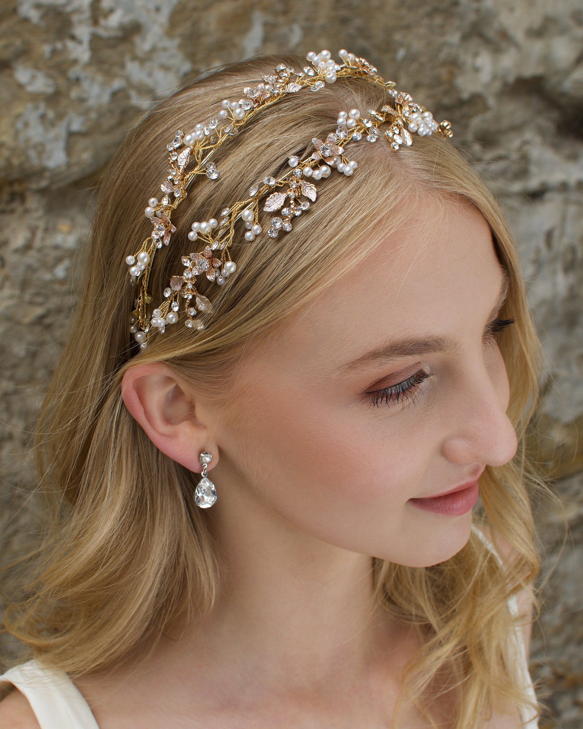 Blonde Bride wearing a Pale gold headband with a stones background
