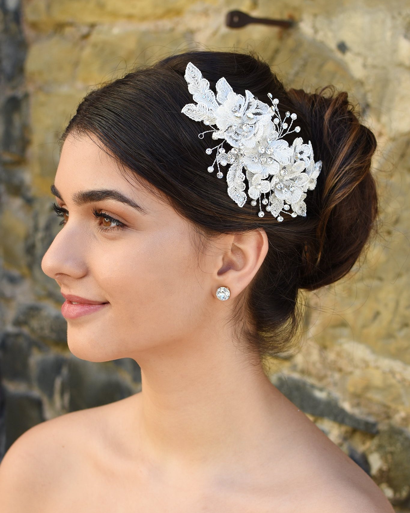 White Lace Bridal side comb with a few stones and pearls shown on popular Bridal hairstyle