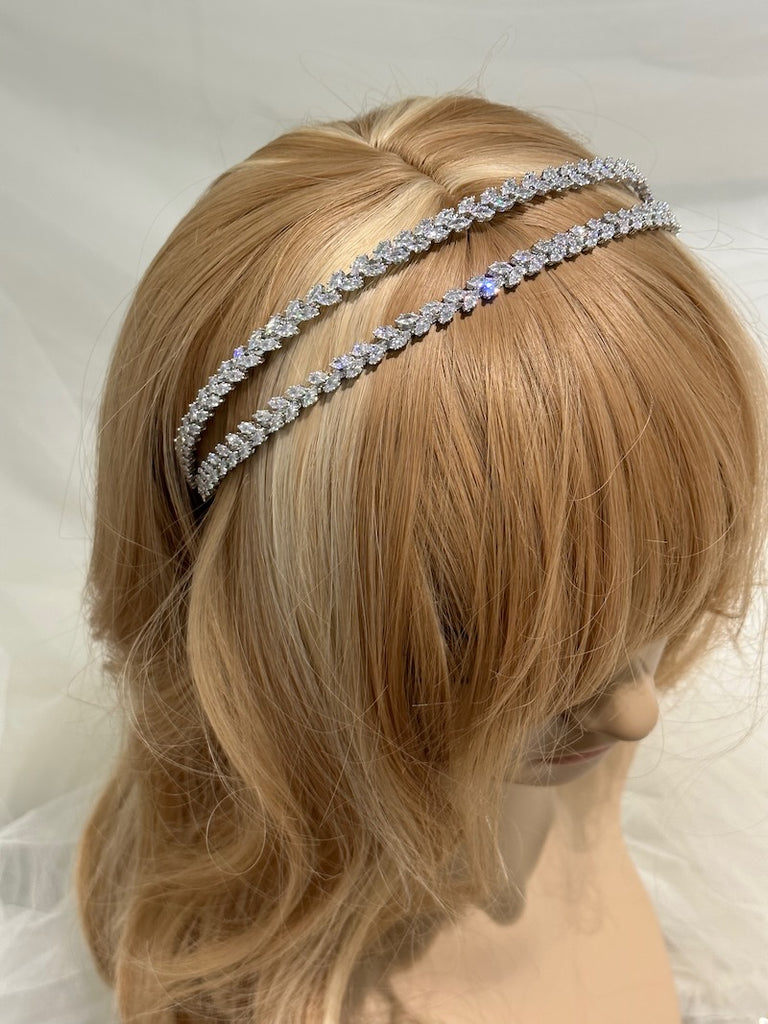 a two row headband in silver colour made of tiny boat shape crystals on a models head