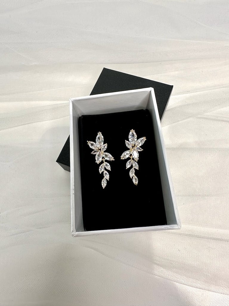 Celia Gold Bridal Earrings in an earring box on black velvet