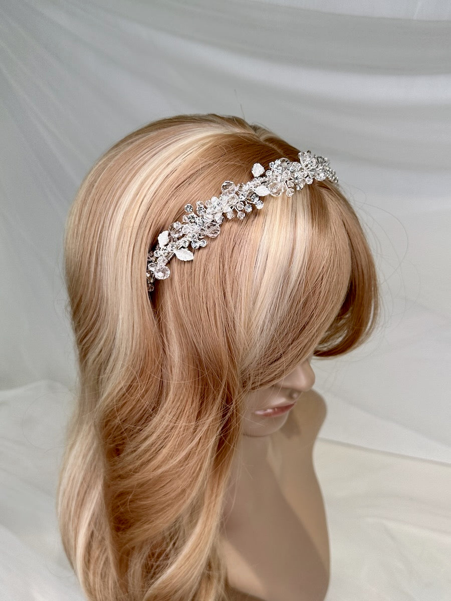 A modern silver crystal headpiece worn on a model head