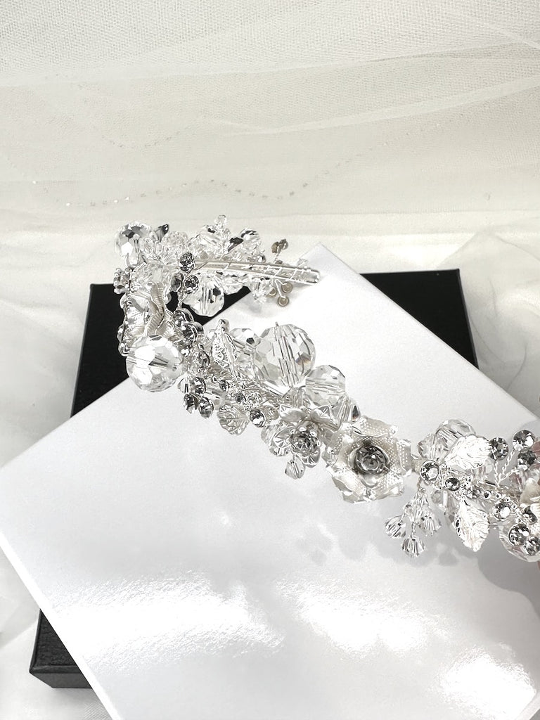 A headband with silver ball crystals called Quinn shown in a display box