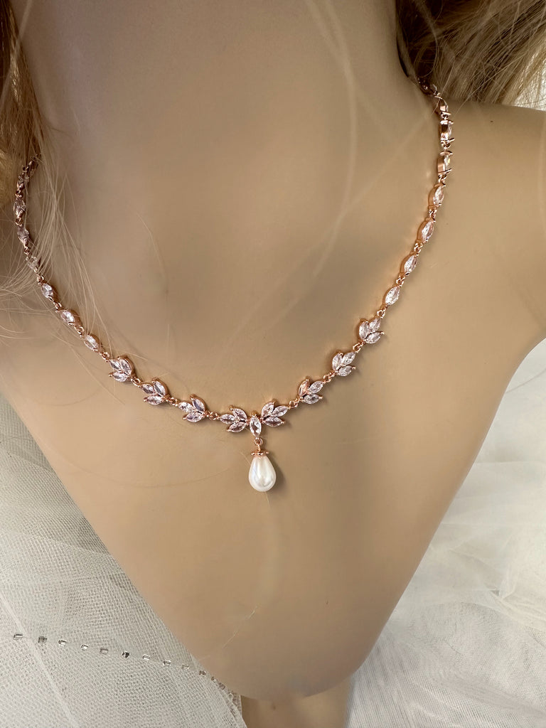 A Leah rose gold bridal necklace worn on a model neck