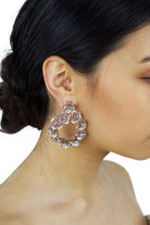 Rose Gold ring of flowers earring  worn by a dark hair model