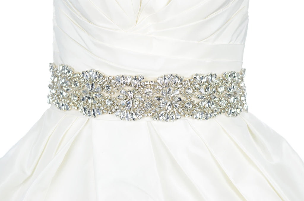 Wide crystal stones belt on ivory ribbon worn on an ivory bridal gown with white background