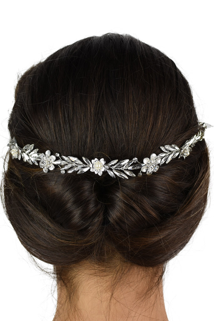 Back of a dark models head who is wearing a simple single strand Bridal Vine with a white background