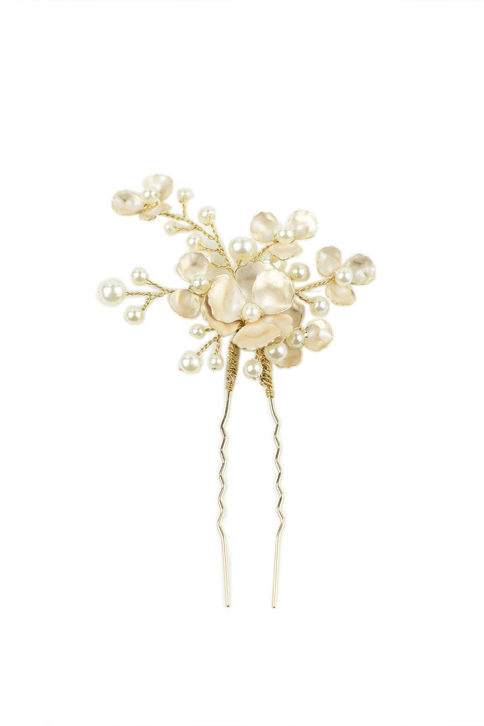 Small pearl and gold hairpin on a bright white background