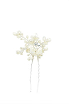 Silver and pearl hair pin on a white background