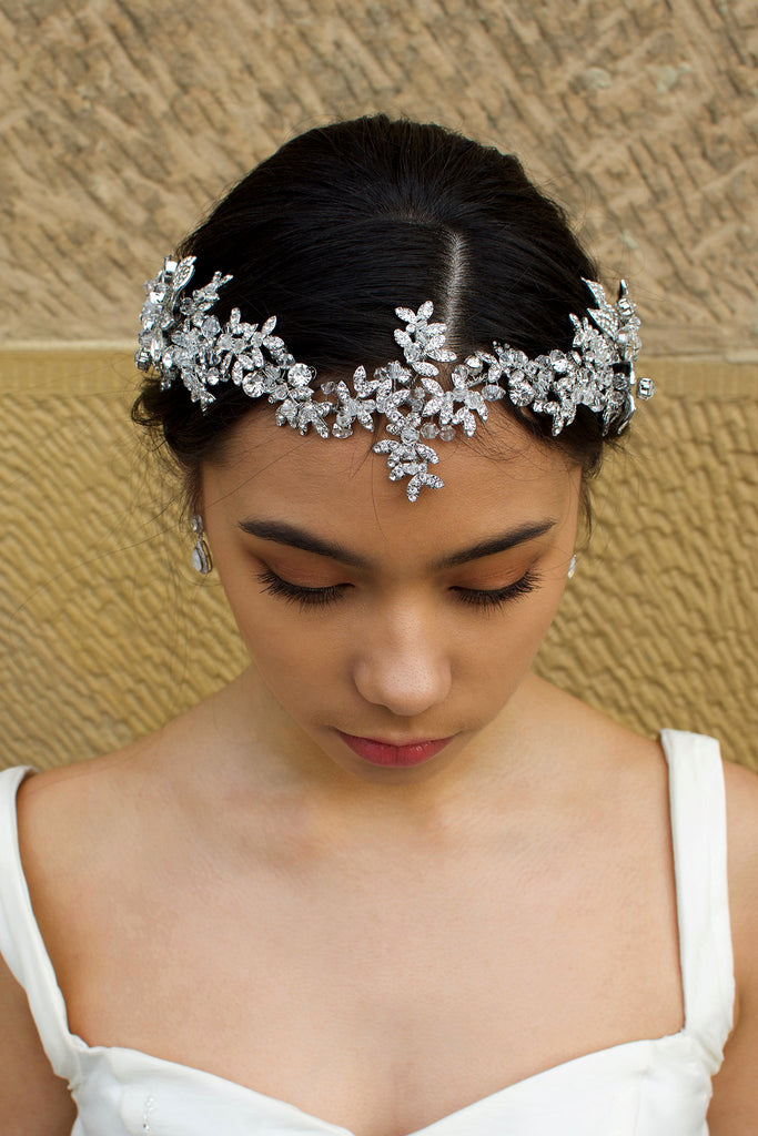 Long Bridal Vine in Dark Silver and crystal worn on the front of a Brides head in front of a stone wall