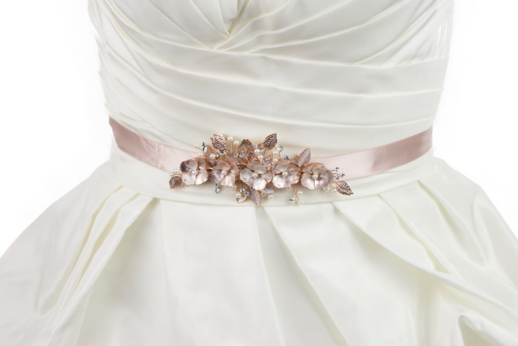 Soft Rose Gold Flowers on a dusty pink satin ribbon bridal belt worn on an ivory bridal gown