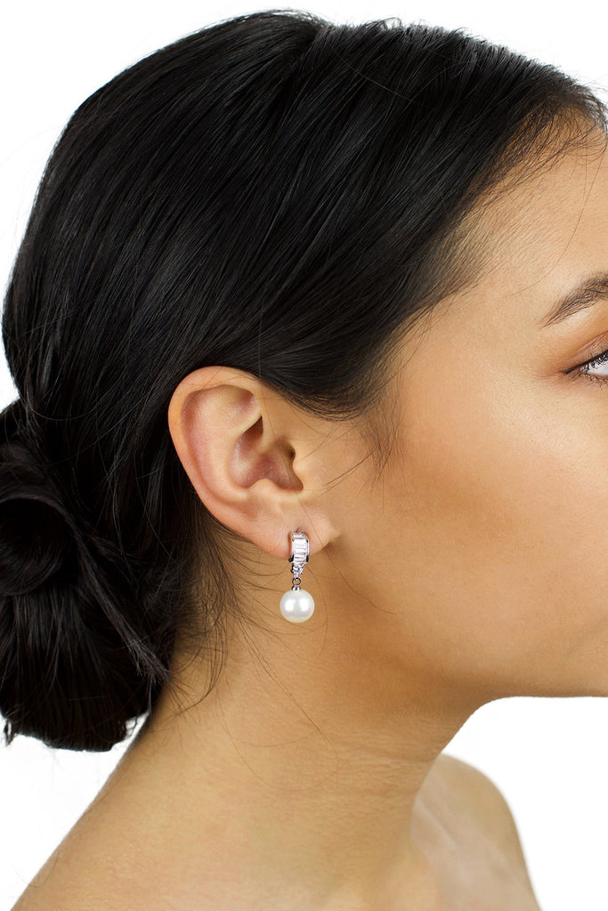 Small pearl earring with clear stones worn by a dark haired bridal model
