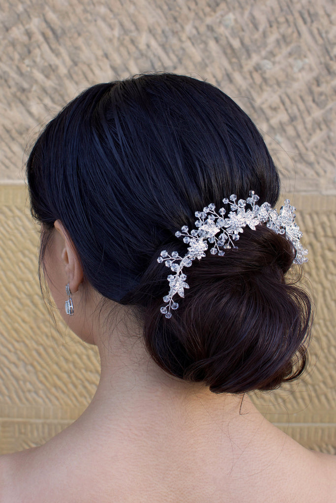 Clear crystal and silver short hair vine worn by a dark haired bride