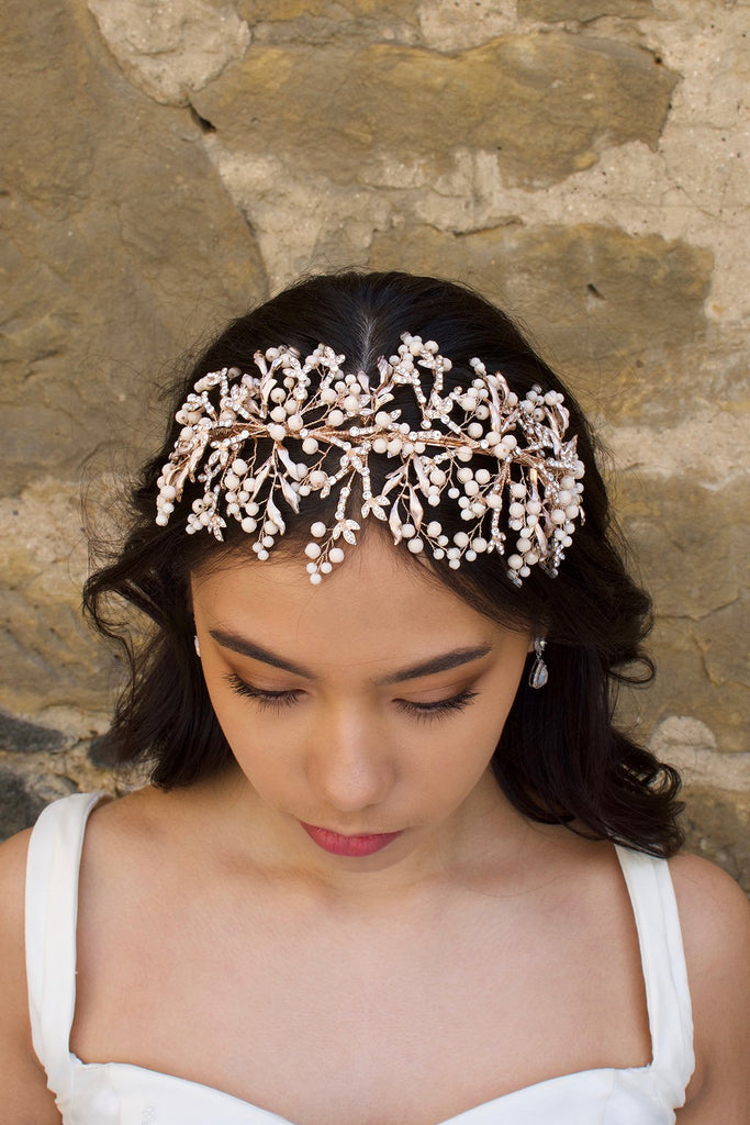 Rose Gold Bridal Headband with coral colour beads worn at the front of a brides head