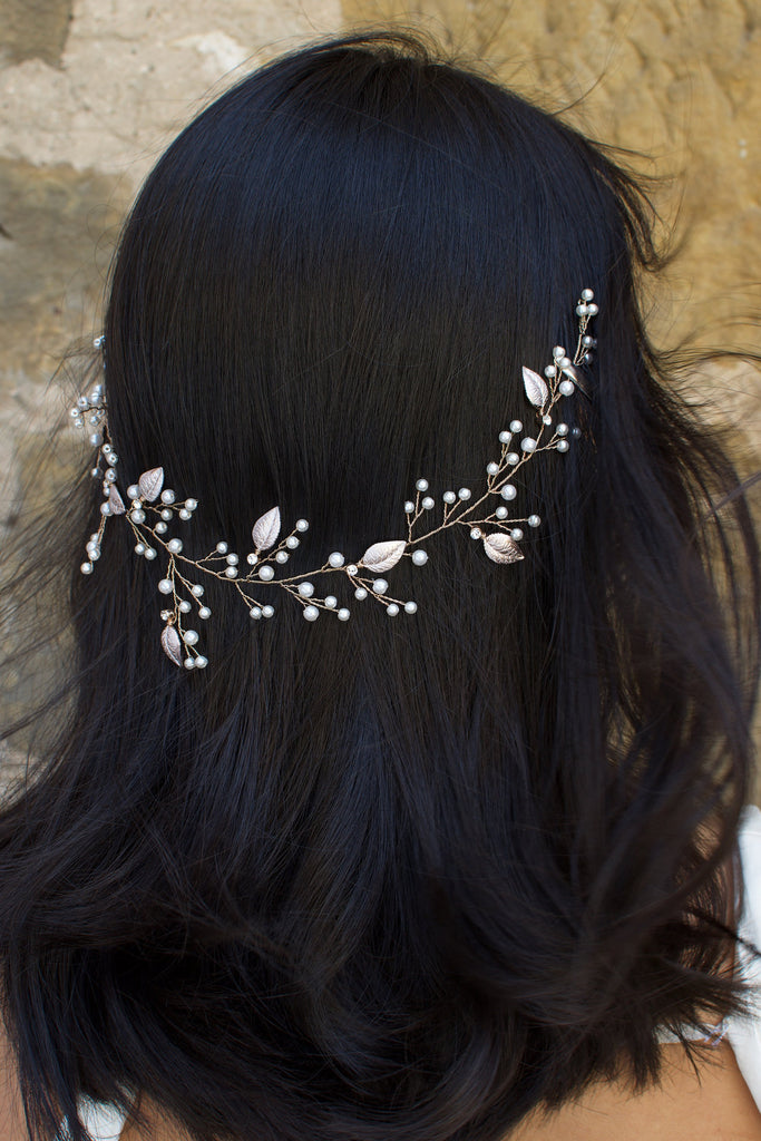 A dark haired Bride wears a thin wire Bridal Vine with leaves and pearls. 