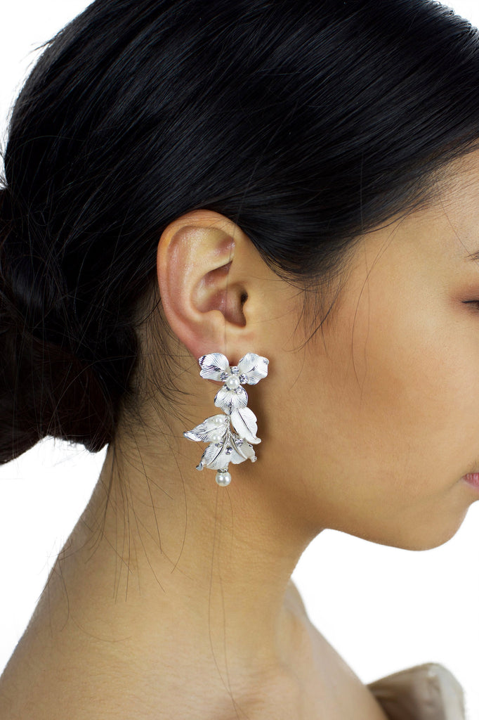 Silver Statement Bridal earring with flowers and white effect worn by a bride with dark hair