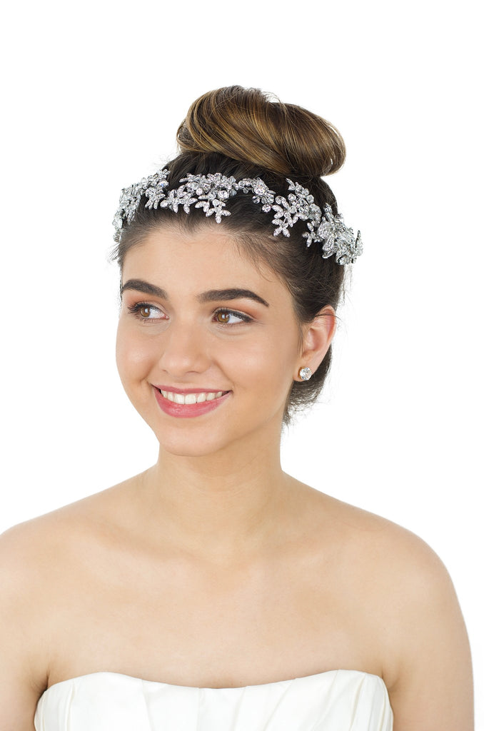 Brown eye Brown hair smiling model wearing long silver bridal vine with white backdrop