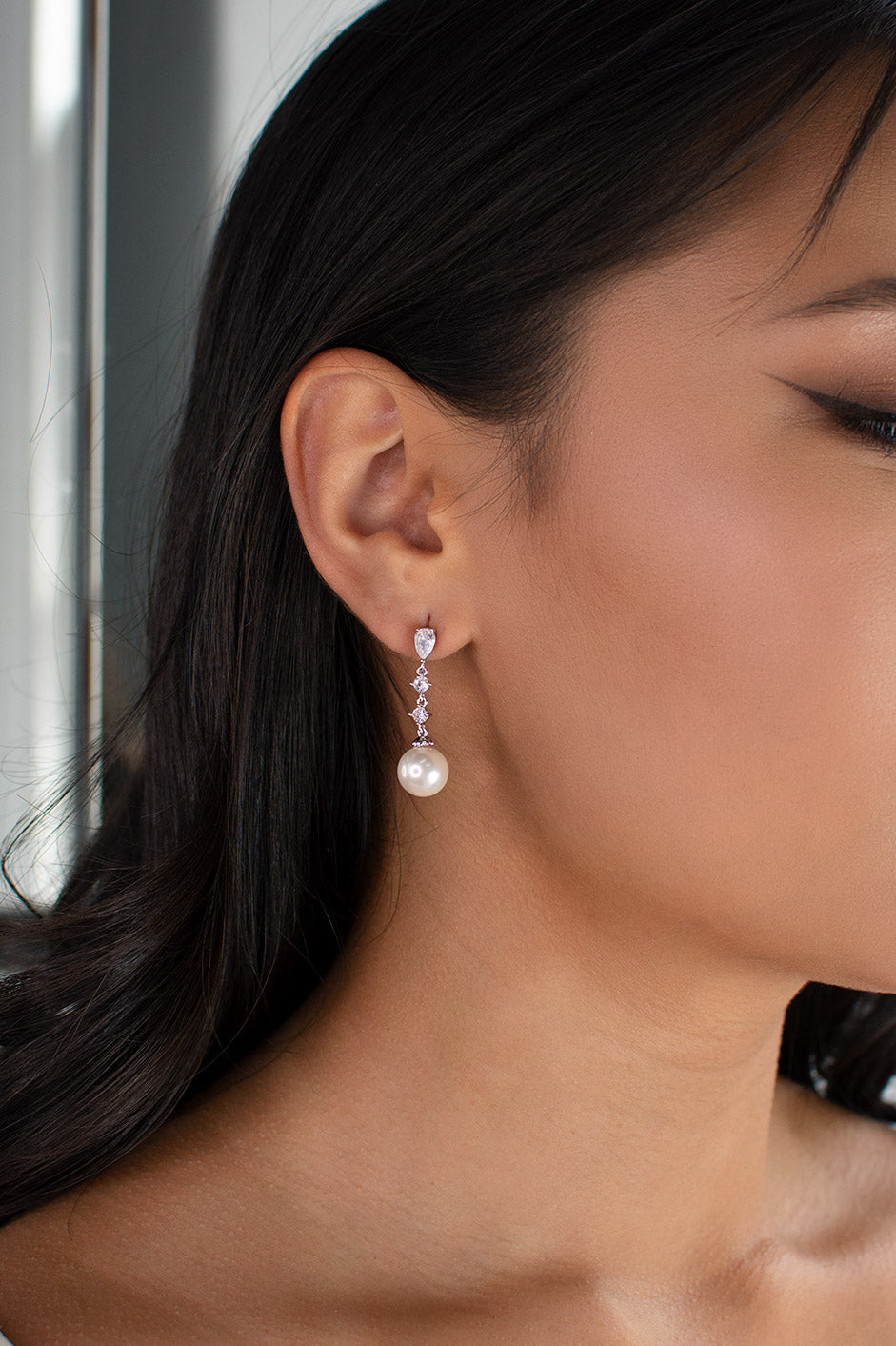 Brielle Silver Pearl Bridal Earring worn by a dark haired model