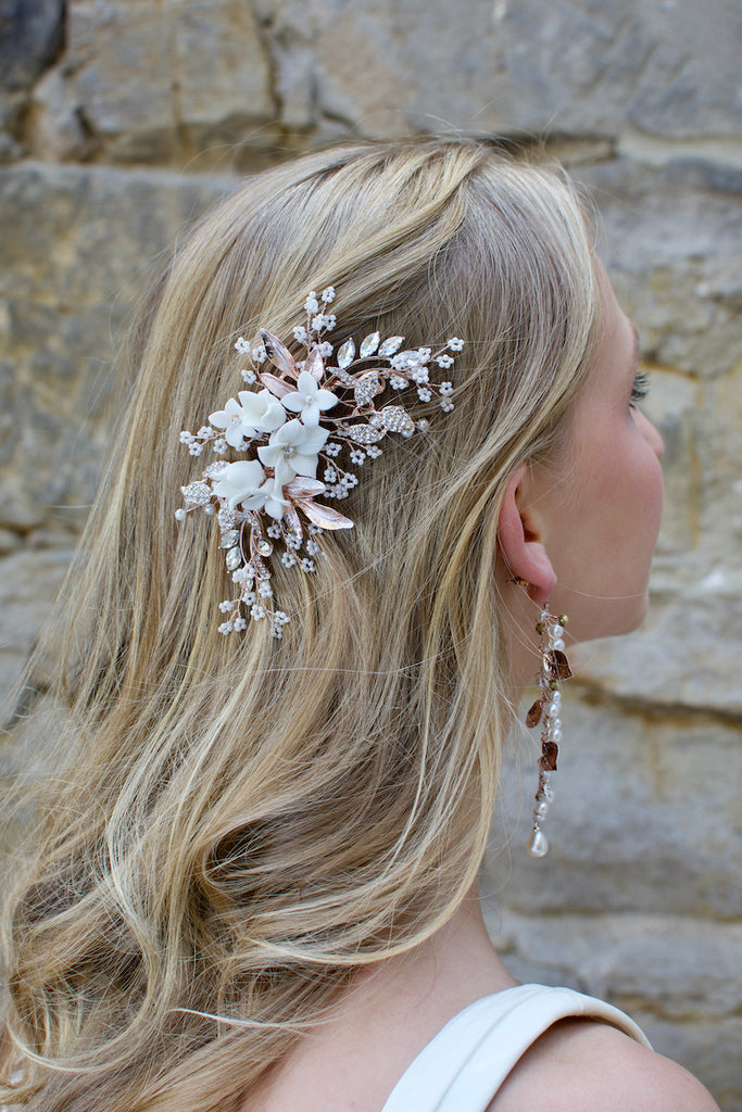 Pale Rose Gold bridal side clip with Porcelain flowers and pearls worn by a blonde model on the side of her head