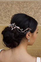 Side view of a Bridal Model with Pale Rose Gold Hair Vine with a stone background