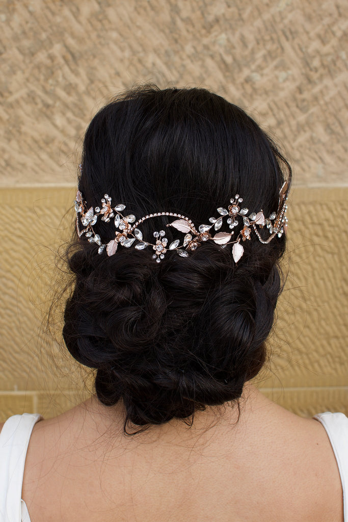 Pale Rose Gold Bridal Hair Vine on Dark Hair Model with a stone wall background