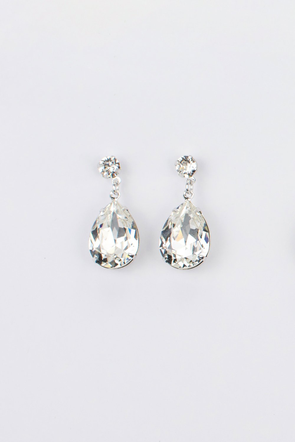 Bright Silver earring in a pear shape with clear swarovski stones