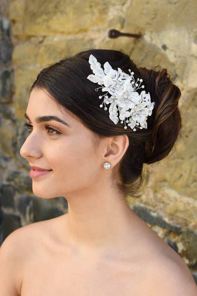 White Lace Bridal side comb with a few stones and pearls shown on popular Bridal hairstyle